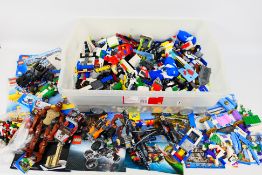 Lego - A tub of loose Lego pieces from a verity of sets.