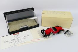 Franklin Mint - A 1928 Stutz Blackhawk Boat Tail Roadster with display case.