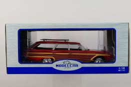 Model Car Group - A boxed 1:18 scale Model Car Group MCG18074 Ford Country Squire with roof rack.