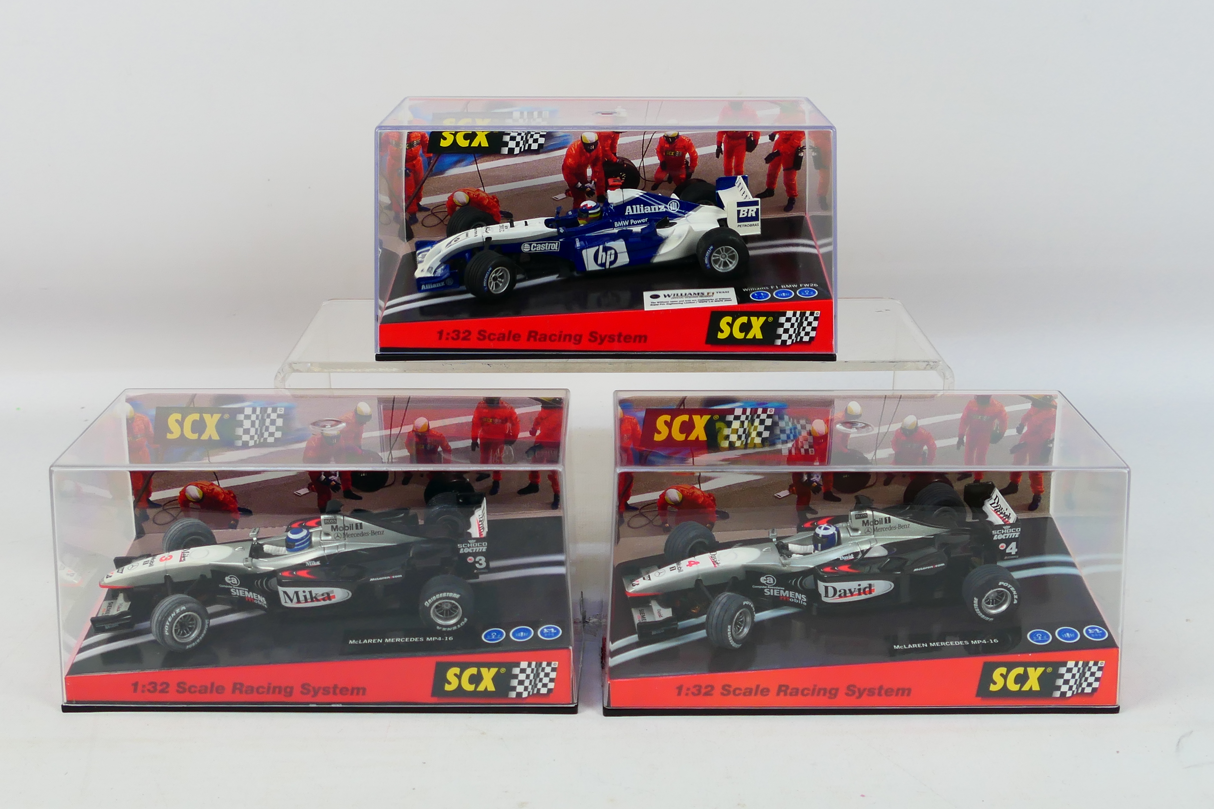 SCX - Three boxed 1:32 scale F1 slot cars.