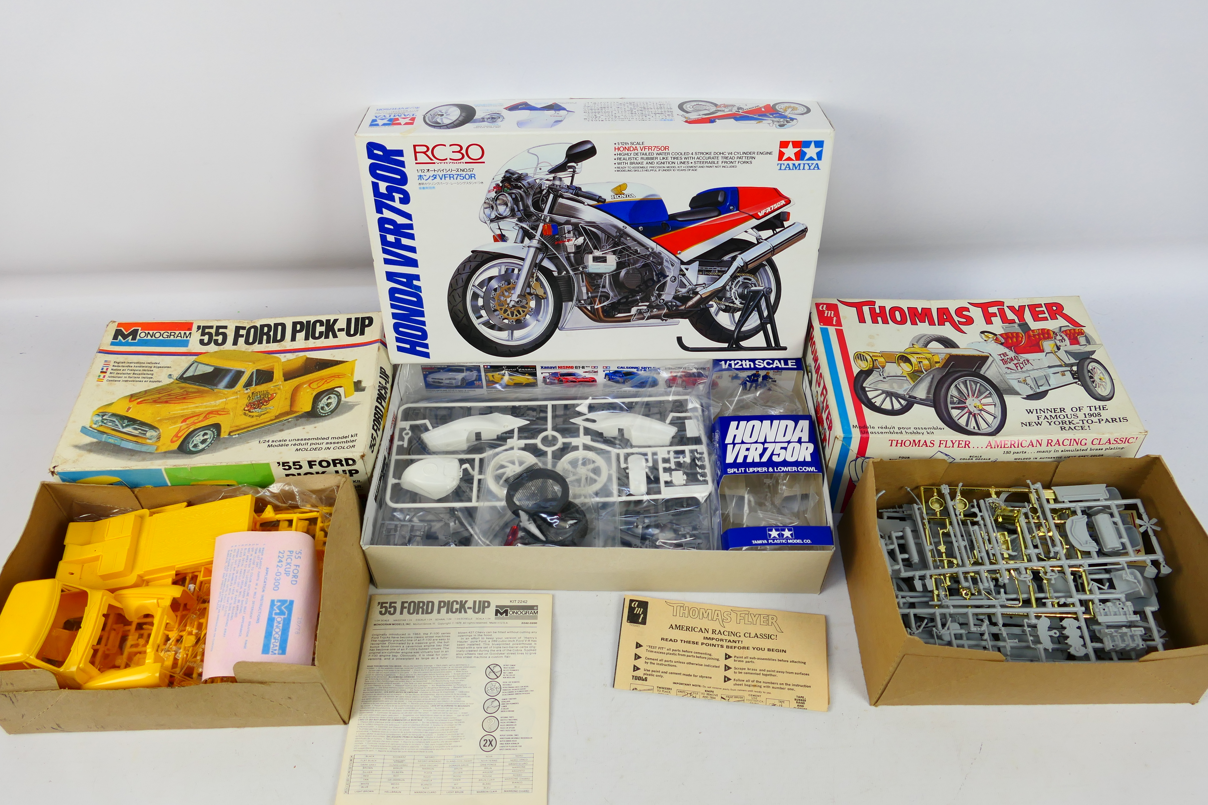 Tamiya - AMT - Monogram - Three boxed plastic model kits in various scales.