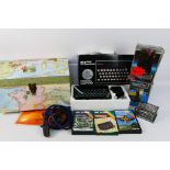 Sinclair - A boxed Sinclair ZX Spectrum with 7 x boxed games cassettes, 2 x boxed Deluxe Joysticks,