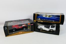 Maisto - Three boxed 1:18 scale diecast model cars from Maisto.