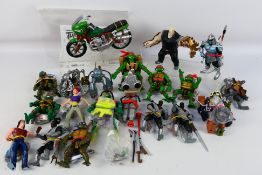 Playmates - An unboxed collection of Teenage Ninja Mutant Turtle action figures and accessories.