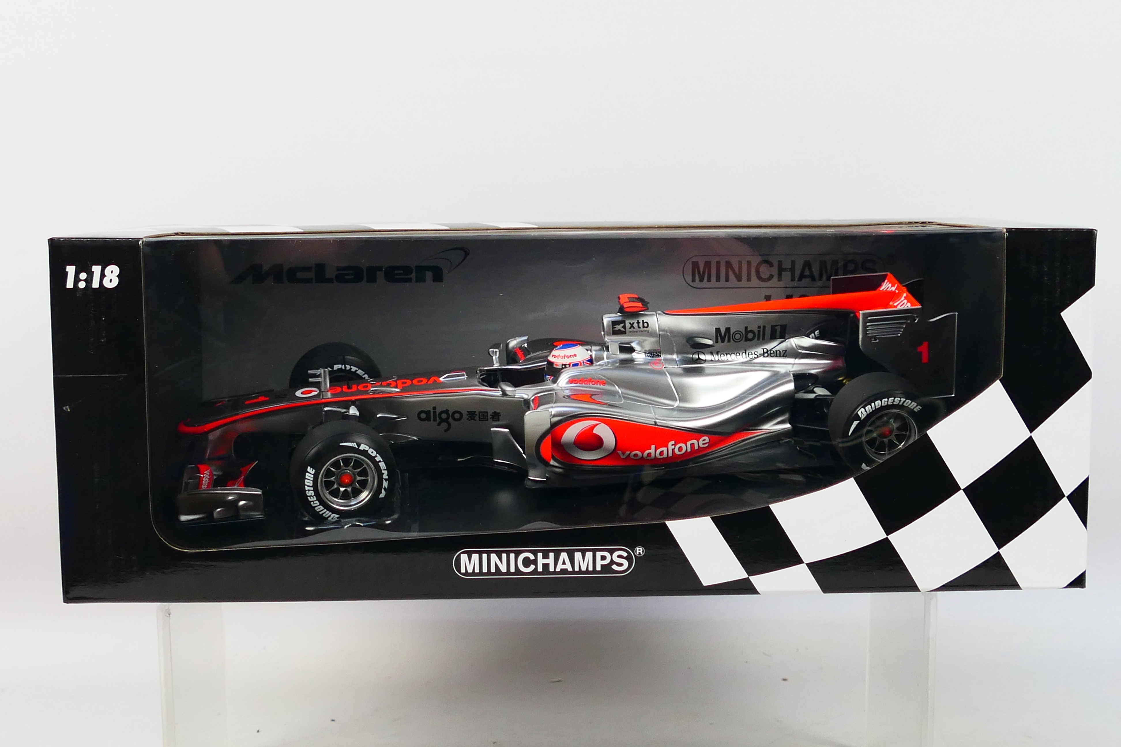 Minichamps- A boxed 1:18 scale McLaren Mercedes MP4-25 Jenson Button car which appears Mint in a
