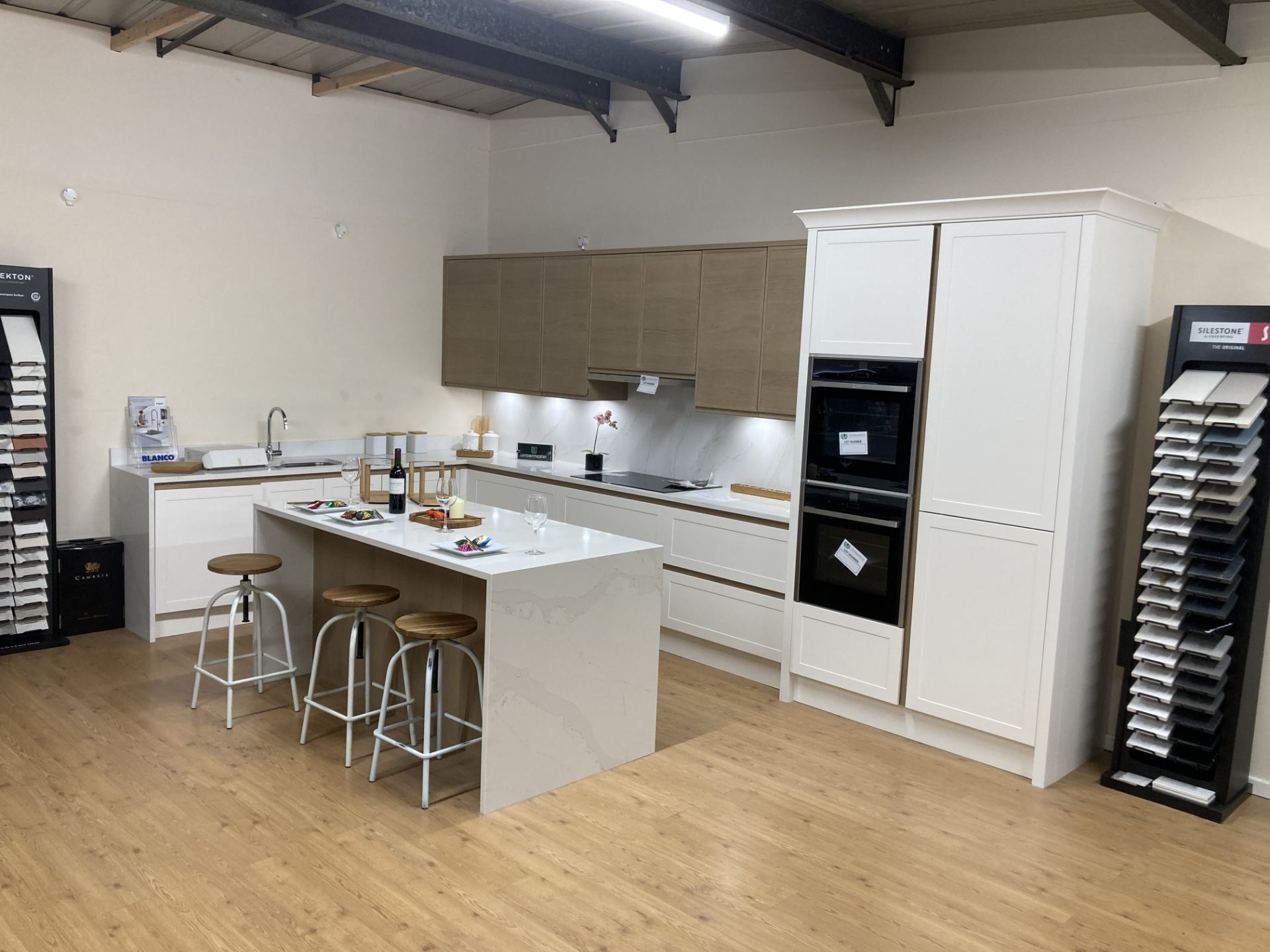 Chalk and oak kitchen display with island unit with appliances