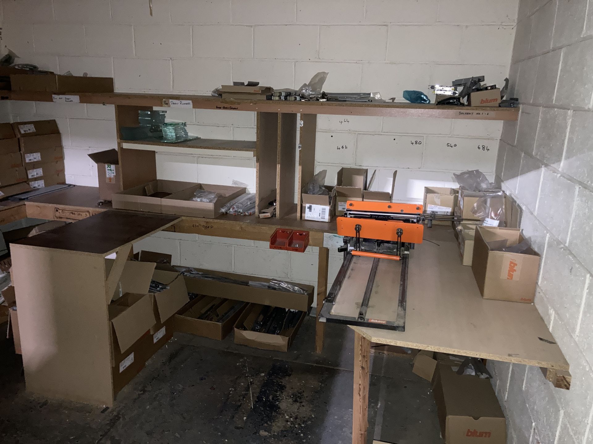 A quantity of drawer components and manual assembly jig