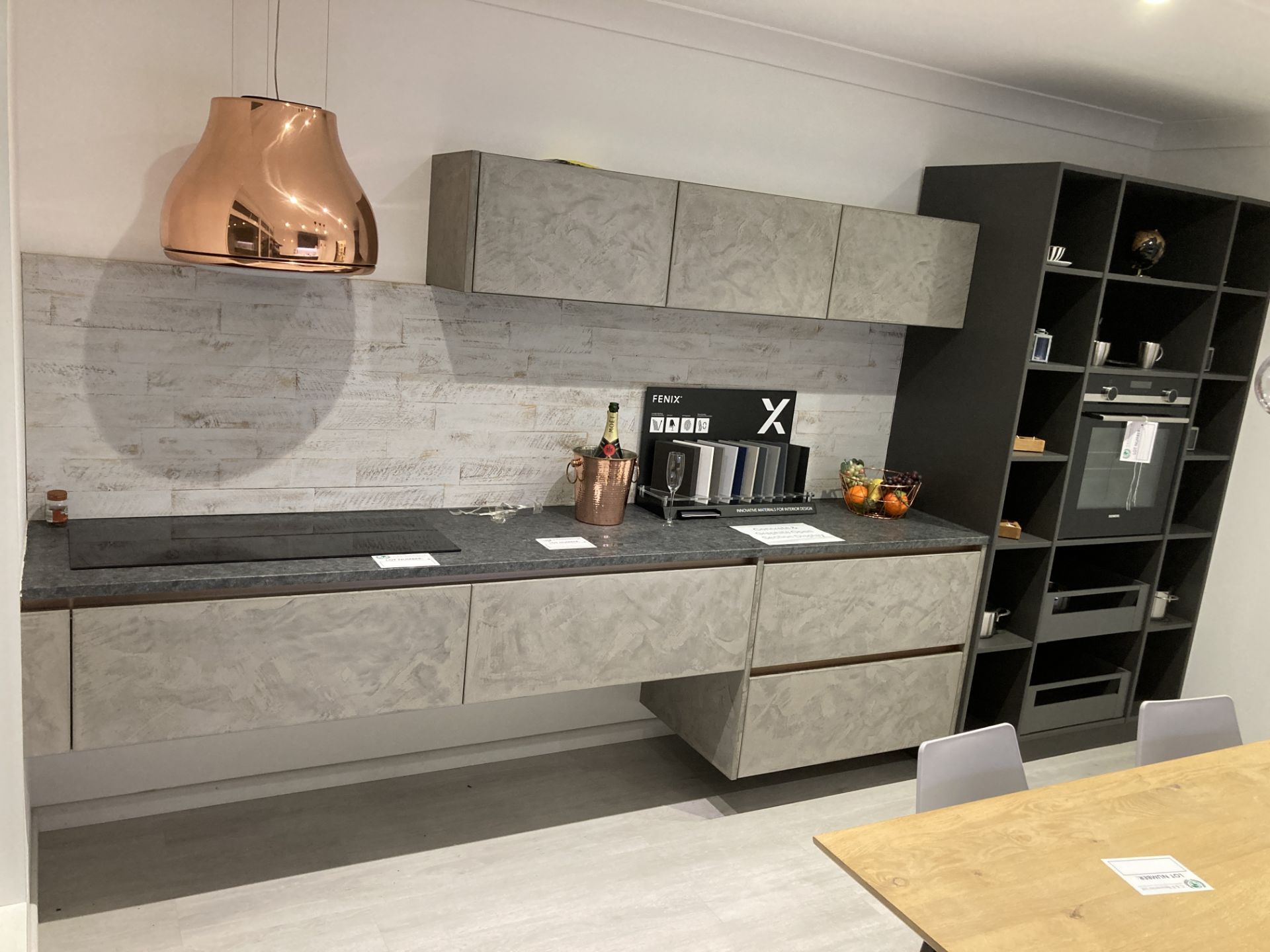 Concrete and graphite open section kitchen display with appliances