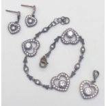 A set of fancy 925 silver CZ heart jewellery include a pendant, a pair of earrings and a 19cm link