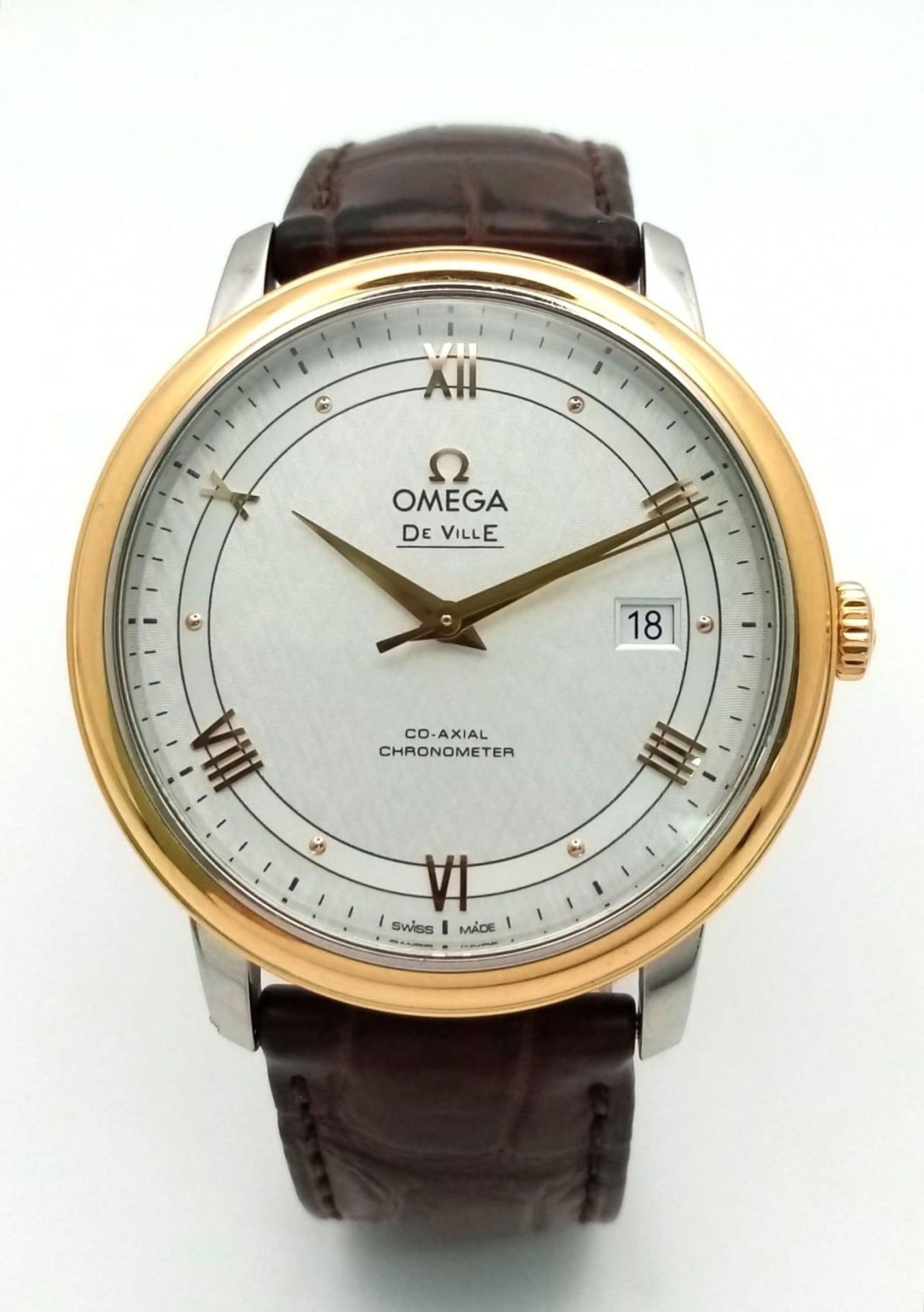 An Omega Deville Prestige Co-Axial Gents Watch. Brown leather strap. Gilded stainless steel case -