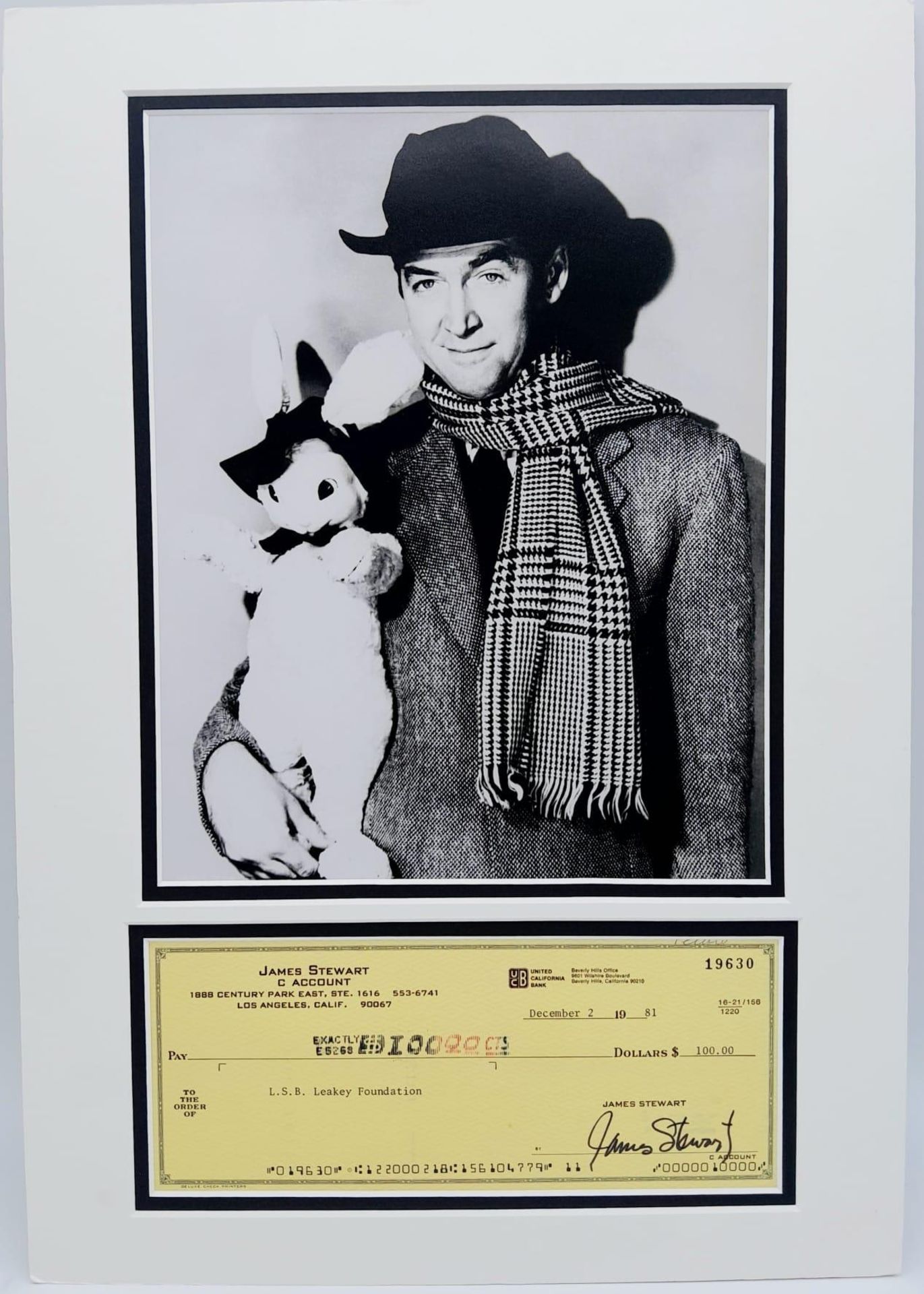 A PHOTO OF JIMMY STEWART AND THE FAMOUS WHITE RABBIT "HARVEY" WITH A SIGNED CHEQUE FROM HIS PERSONAL