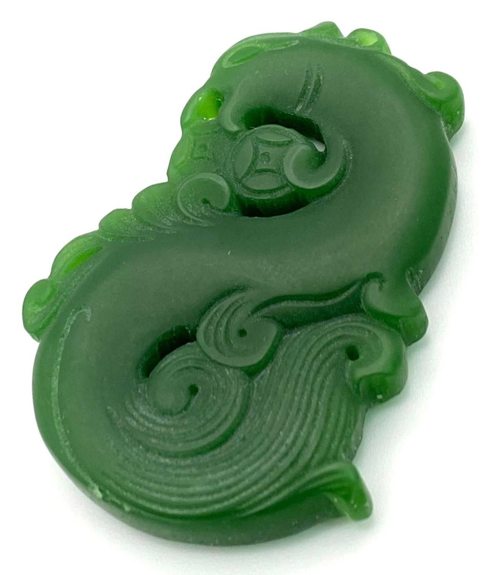 A Chinese Green Jade Swirling Dragon Pendant. 5cm - Image 2 of 3