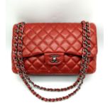 A Chanel Red Quilted Caviar Double Flap Jumbo Bag. Diamond quilted exterior with CC logo clasp.