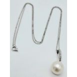 A 9K White Gold Round Freshwater Pearl and Diamond Pendant on a 9K White Gold Chain. Boxed. Diamonds