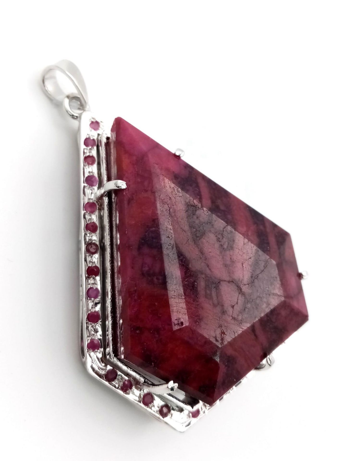 Make a massive statement! This 106.5 gram, Sterling Silver framed, 394ctw Ruby Pendant. Measures 8cm