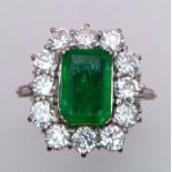 A Head-Turning 18K White Gold, Emerald and Diamond Ladies Dress Ring. Rectangular emerald with a