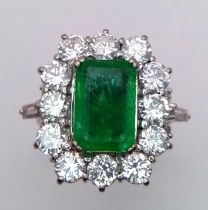 A Head-Turning 18K White Gold, Emerald and Diamond Ladies Dress Ring. Rectangular emerald with a