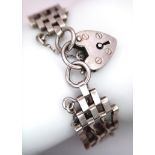 A vintage sterling silver gate bracelet with heart padlock silver charm. Total weight 15.8G. Total