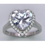 A Silver Ring Set With a Large White Zirconia Heart at the Centre. Size Q.