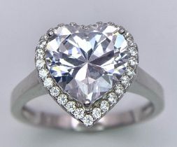 A Silver Ring Set With a Large White Zirconia Heart at the Centre. Size Q.