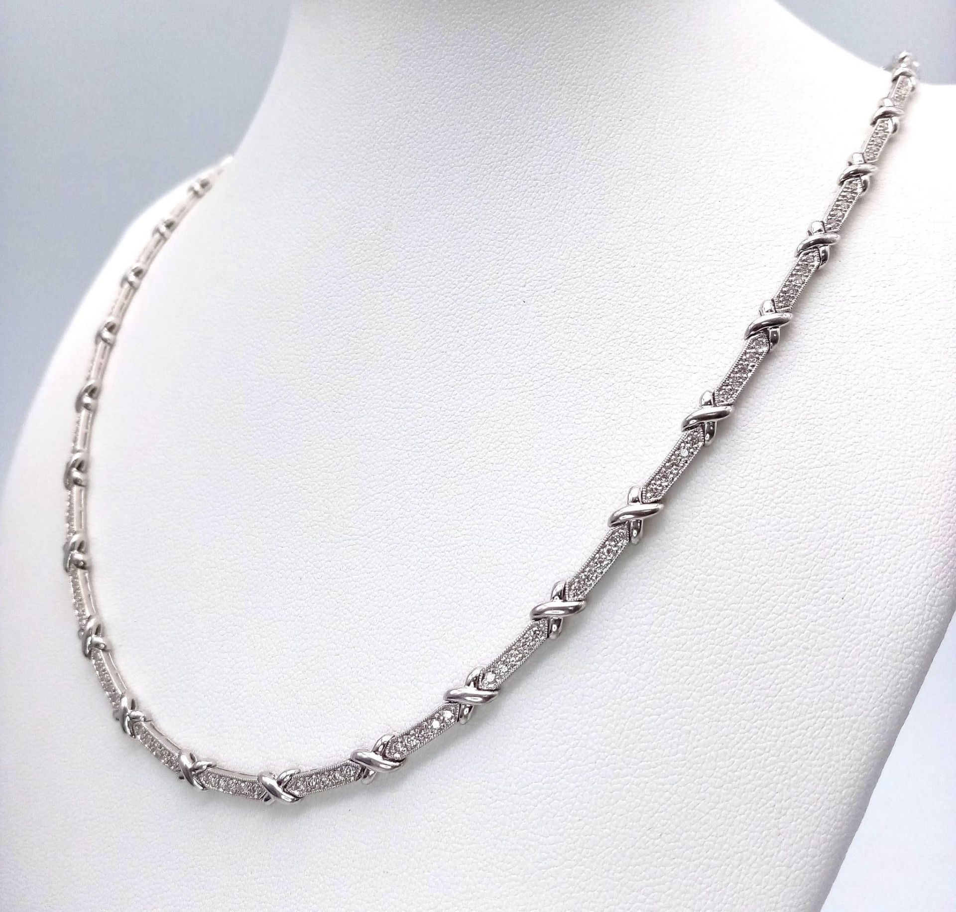 An 18K White Gold and Diamond Bar Link Necklace. 1.24ctw of diamonds. Love-knot separators. 43cm - Image 3 of 6