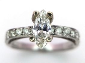 A VERY PRETTY MARQUISE CUT SOLITAIRE DIAMOND WITH TWIN BAND AND SHOULDER DIAMONDS. 3.05gms size N