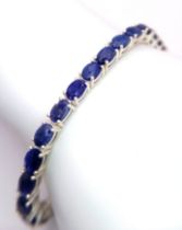 A Oval-Cut, Blue Sapphire tennis bracelet, set in Sterling Silver. This stylish bracelet measures