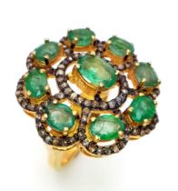An Emerald and Diamond Gemstone Ring set in Gold Plated 925 Silver. 12ctw of decorative floral