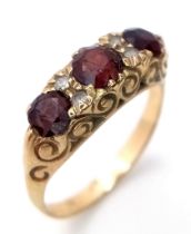 An ornamental, vintage, 9 K yellow gold ring with garnets and white sapphires. Ring size: Q, weight: