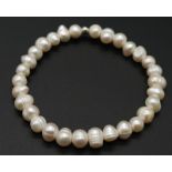 White Pearl Stretch Bracelet. Measuring 6cm in diameter.