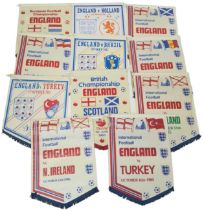 A COLLECTION OF 11 ENGLAND FOOTBALL MATCH PENNANTS FROM DIFFERENT INTERNATIONAL MATCHES ,