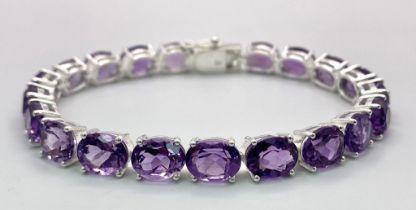 An Amethyst Gemstone Tennis Bracelet set in 925 Silver. 19cm length. 21.10g total weight. Ref: CD-