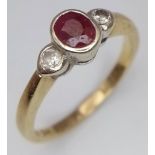 A 9 K yellow gold ring with an oval cut ruby and two round cut diamonds (0.10 carats), ring size: