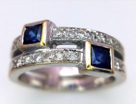 A Stylish 18k White Gold and Diamond Ring. Two rows of diamonds with square cut sapphire orbiters.