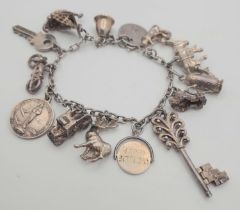 A vintage sterling silver charm bracelet with multiple charms such as a palace, dragon ship, etc.