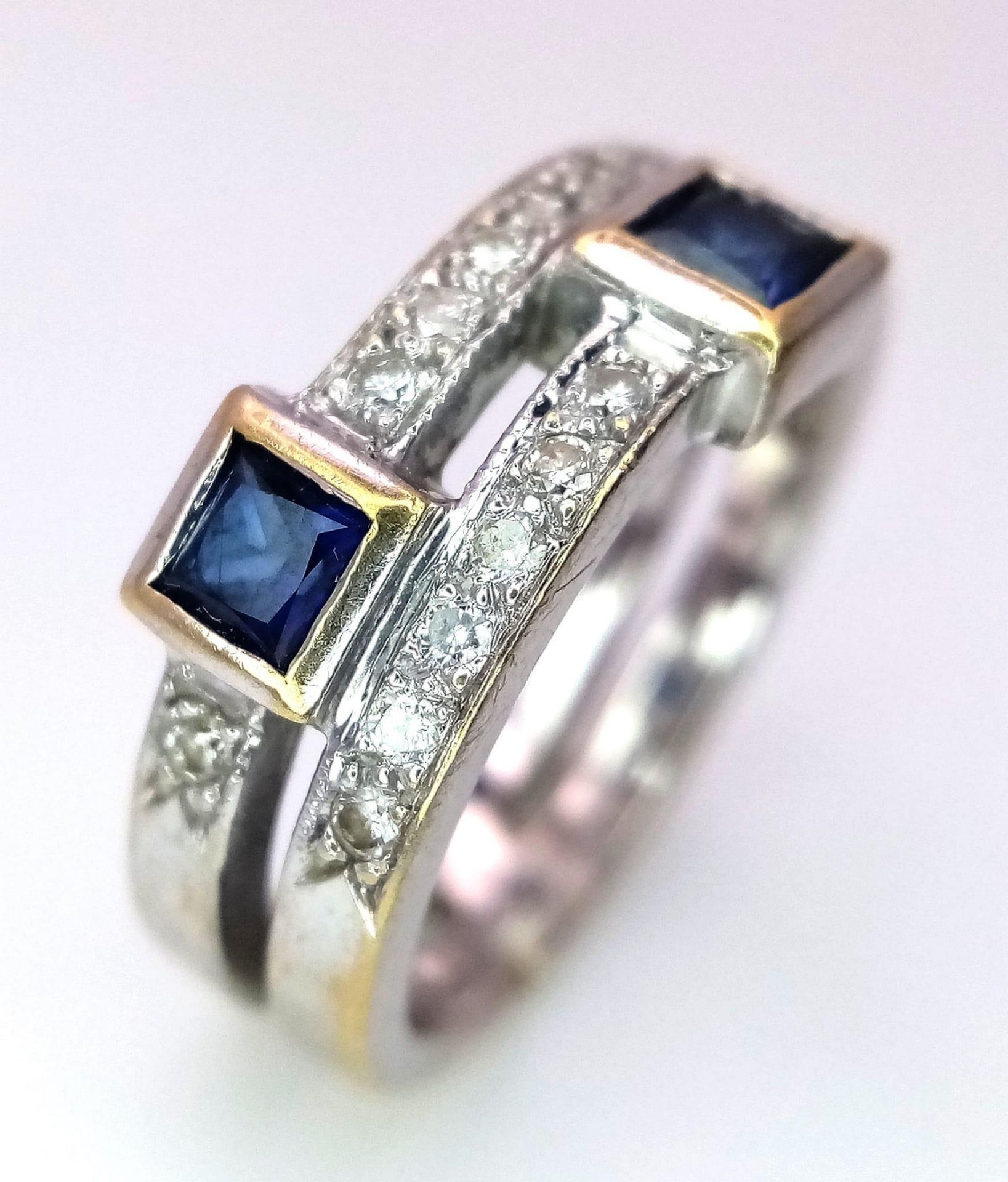 A Stylish 18k White Gold and Diamond Ring. Two rows of diamonds with square cut sapphire orbiters. - Image 2 of 4