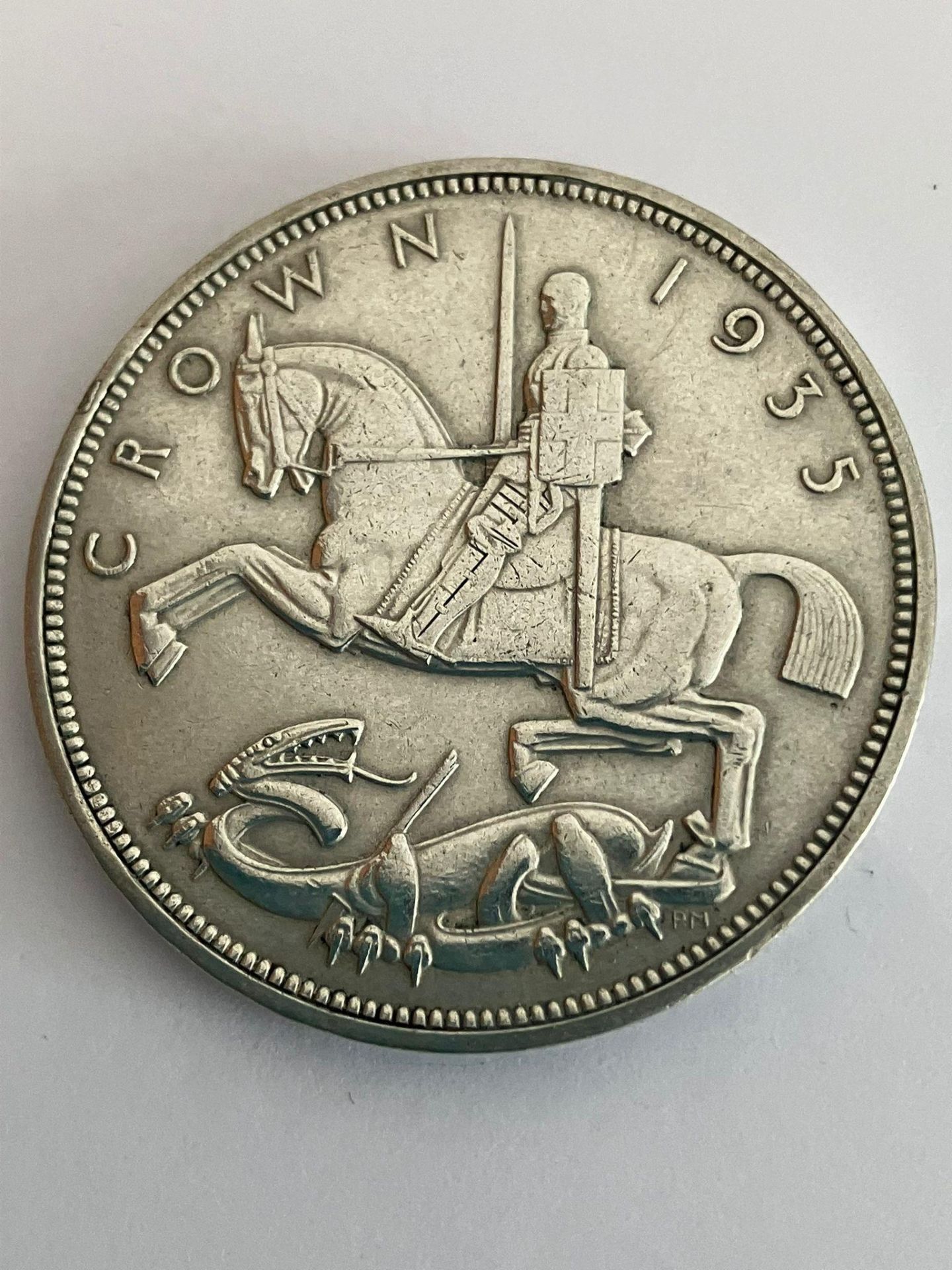 1935 SILVER ROCKING HORSE CROWN. Raised detail and definition to sides, with clear wording to