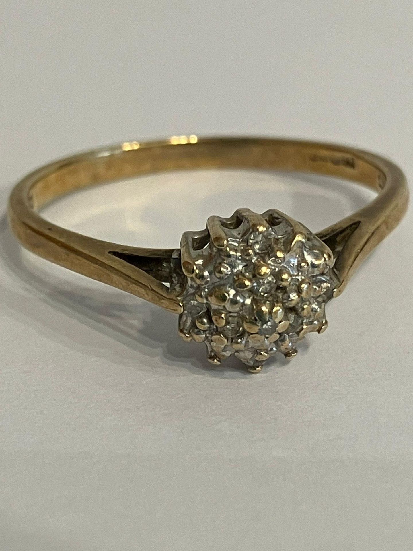 9 carat YELLOW GOLD and DIAMOND CLUSTER RING. Complete with ring box. Full UK hallmark.1.85 grams.