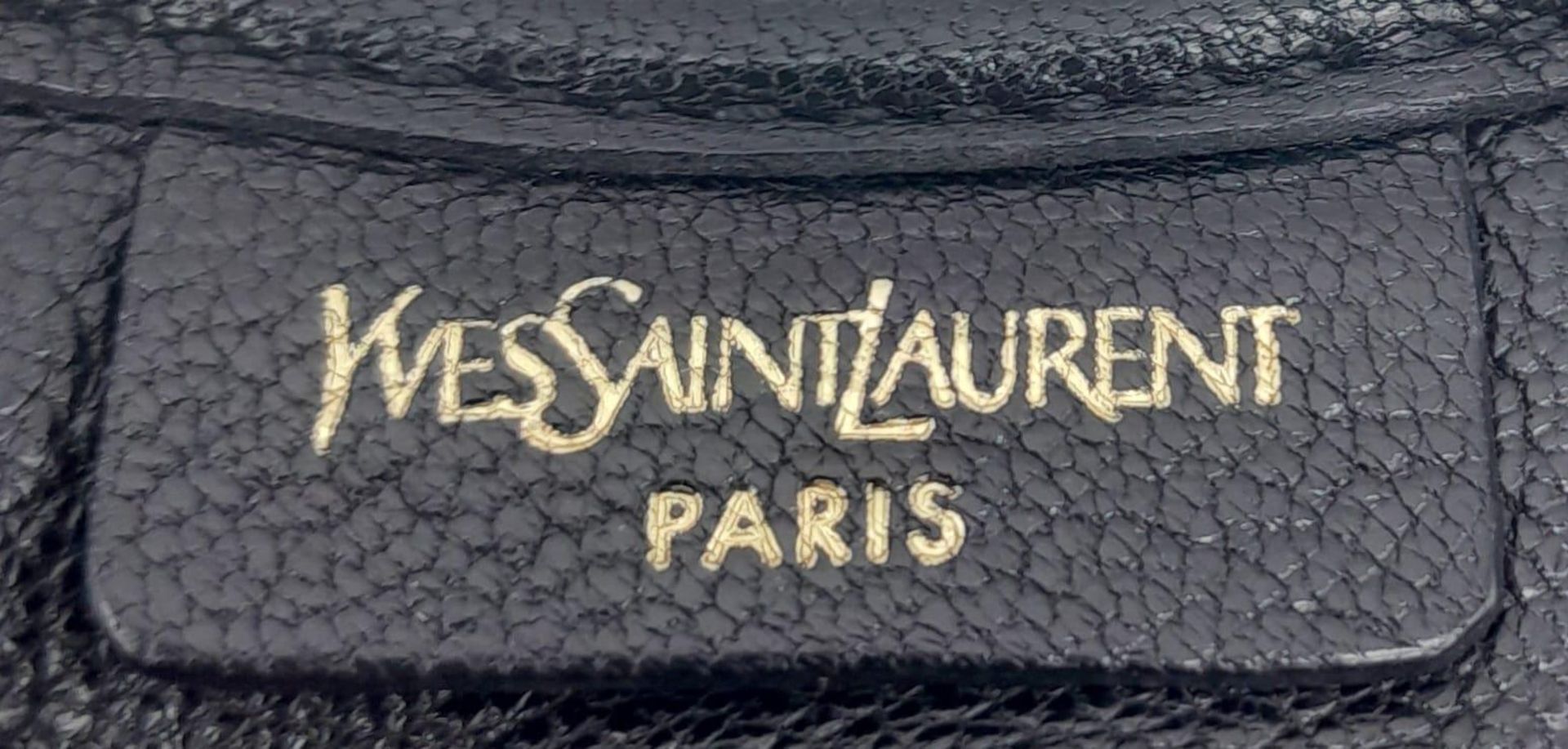 A YSL Saint-Tropez Handbag. Black leather strip exterior. Horn shaped handle. Textile interior - Image 8 of 8