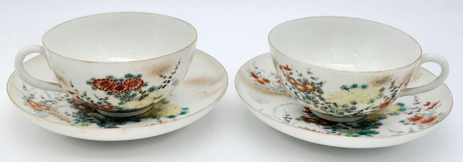 A pair of antique Japanese, hand-painted cup and saucer. Fine bone china with a delightful floral