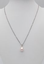 A sterling silver chain necklace with a tear drop shaped natural pearl pendant. Chain length: 44 cm,