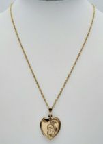 A 46cms 9K GOLD CHAIN WITH A 9K GOLD BACK AND FRONT PATTERNED LOCKET . 5.6gms