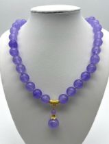 A Lavender Jade Bead Necklace with Pendant Drop. Gilded accents and clasp. Necklace length - 44cm.