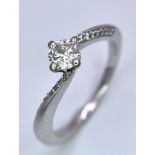 An 18k White Gold Diamond Crossover Ring. 0.25ct approx central stone. Size L. 2.55g total weight.