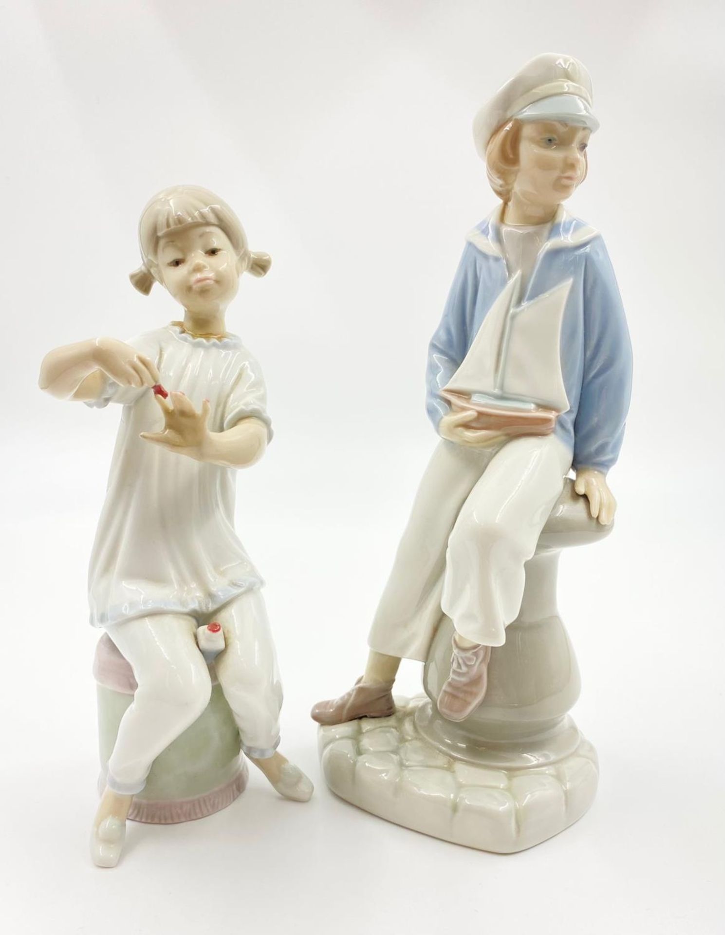 A Selection of Two Lladro Figurines. 22cm tallest piece.