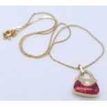 An Italian 14k Yellow Gold Pendant in the Shape of a Handbag with Red Glitter Enamel Detailing on