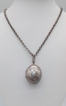 A vintage silver locket pendant with flower motif on 925 silver link chain. Total weight 18G.