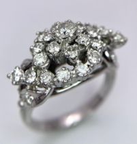 A Fancy Cluster Ring - Set with 1.1ctw of round cut diamonds. Set in white metal. Size O