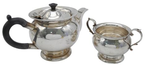 An antique sterling silver tea set include a milk jug and a tea pot. Full hallmarks London, 1921.