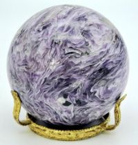 A top quality, totally natural and undyed sphere of CHAROITE on a custom-made gilded metal base.